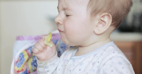 Baby boy eating a lemon