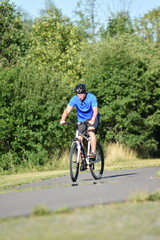 Fototapeta na wymiar Adult Male Athlete And Loneliness Wearing Helmet Riding Bike