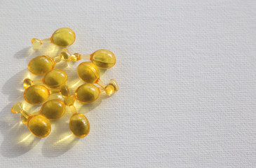yellow vitamin pills on white background