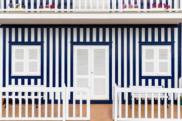 Colored Windows of "Costa Nova do Prado", Portugal. Windows in typical small wooden house with colorful stripes in Costa Nova. Aveiro. Portugal. Detail of the house in famous resort Costa Nova.