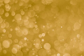 abstract soft bokeh light effect with yellow gold background