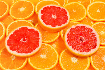 Naklejka na ściany i meble Slices of oranges and a grapefruits as a background.