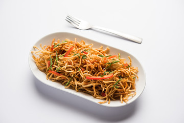 Chinese Bhel is a spicy indo-chinese recipe, served in a bowl. selective focus