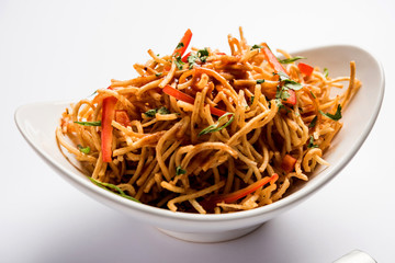 Chinese Bhel is a spicy indo-chinese recipe, served in a bowl. selective focus