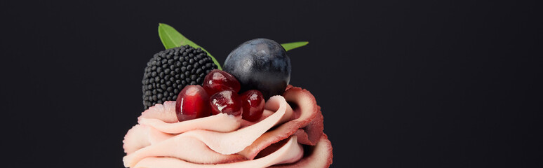 panoramic shot of sweet cream, garnet, grape and blackberry isolated on black