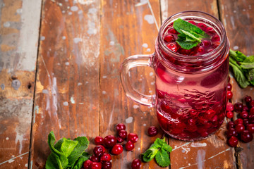 Detox Infused Water with Cranberries and Mint in glass. Healthy food, drinks, fitness, healthy nutrition diet concept. Copy space