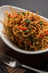 Chinese Bhel is a spicy indo-chinese recipe, served in a bowl. selective focus