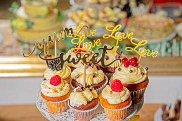 deliciously arranged muffins with cream filling and garnished with fruits on a wedding buffet