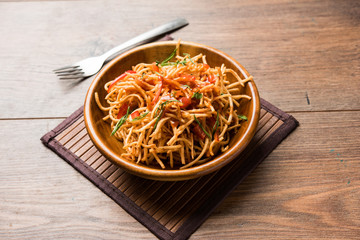 Chinese Bhel is a spicy indo-chinese recipe, served in a bowl. selective focus