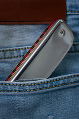 Blues harmonica in the jean pocket