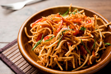 Chinese Bhel is a spicy indo-chinese recipe, served in a bowl. selective focus