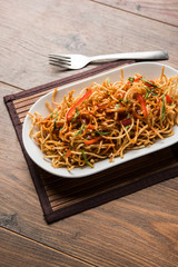 Chinese Bhel is a spicy indo-chinese recipe, served in a bowl. selective focus