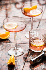Rose wine in wineglasses. Wine tasting, garden party and celebration in the summer. Still life and lifestyle in the garden with artistic shadows.