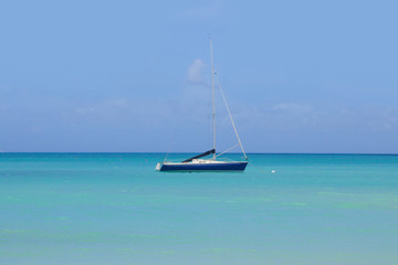 Fototapeta na wymiar A sailboat in the Caribbean Sea. Summer Dreams. Beach - Antigua