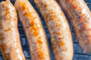 bratwurst, fried sausages on the grill