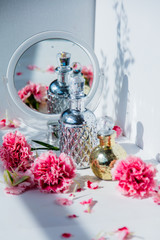 Perfume bottle with mirror and dianthus flowers