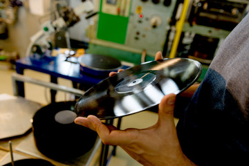 Checking the Vinyl quality. Men holding Vinyl record