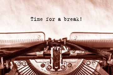 Time for a break printed on a sheet of paper on a vintage typewriter.