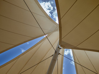 Imitation of sails on the mast against the blue sky on a sunny day.