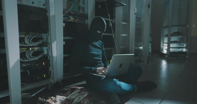 hacker breaks the security system in server room.