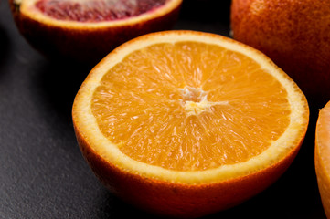 Close up. Sliced in half orange on a black background.