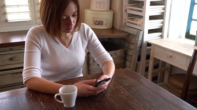 A beautiful asian woman using smartphone sitting at the table