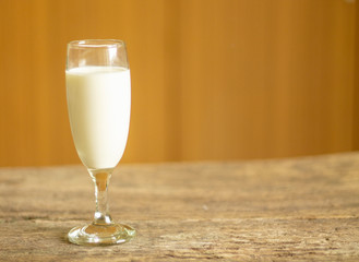 Milk glass placed on an old wooden table