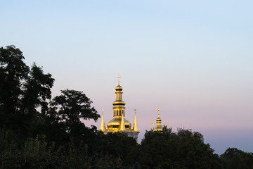Fototapeta na wymiar View from the leaves on the bell tower of the Nativity of the Nativity of the Virgin in Kiev