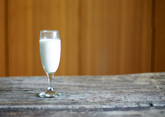 Milk glass placed on an old wooden table
