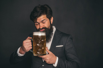 Happy elegant man drinking beer. Beer. Man with beard drink beer.