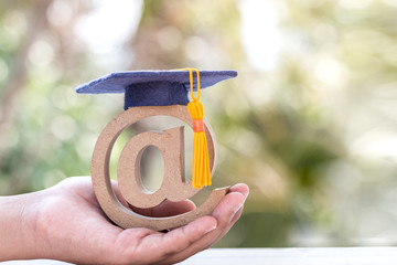 Online Learning in study abroad university education concept: Graduation cap on email address...
