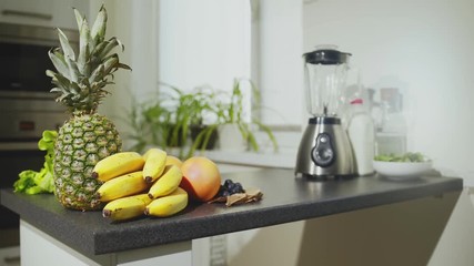 Fresh fruits and mixer on table. Banana, apple, orange, pineapple and grapes - Powered by Adobe