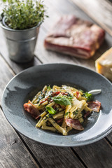 Pasta casarecce with bacon pancetta parmesan cheese and herbs basil. Italian or mediterranean cuisine.