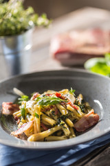 Pasta casarecce with bacon pancetta parmesan cheese and herbs basil. Italian or mediterranean cuisine.