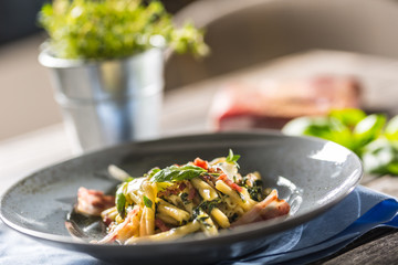 Pasta casarecce with bacon pancetta parmesan cheese and herbs basil. Italian or mediterranean cuisine.