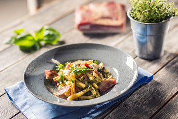 Pasta casarecce with bacon pancetta parmesan cheese and herbs basil. Italian or mediterranean cuisine.