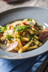 Pasta casarecce with bacon pancetta parmesan cheese and herbs basil. Italian or mediterranean cuisine.