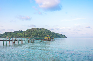 Wooden bridge pier boat in the sea and the bright sky.