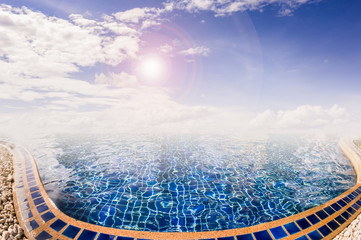 Luxury swimming pool with sunny sky