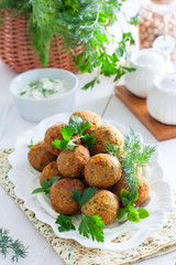 Chickpea falafel with fresh herbs on a white plate, selective focus
