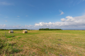 View to harvested Hay Bale with View to the Waddensea at Sylt Braderup/ Germany