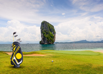 golf equipment on green and hole as background