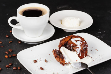 Dessert with hot chocolate muffin and ice cream on a black background.