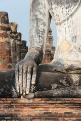 Fototapeta na wymiar statue of buddha in a ruined buddhist temple (Wat Mahathat) in Sukhothai (Thailand)