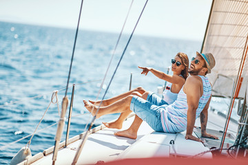 Happy man and woman relaxing on a luxury yacht. couple on cruise..