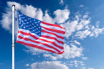 American Flag waving against blue Sky, USA Flag waving as Background