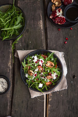 Arugula salad with gorgonzola cheese and pomegranate. Cheese feta, arugula and a piece of pomegranate. Delicious and healthy fitness salad with pomegranate.