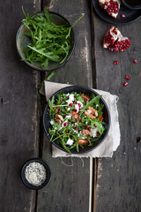 Arugula salad with gorgonzola cheese and pomegranate. Cheese feta, arugula and a piece of pomegranate. Delicious and healthy fitness salad with pomegranate.