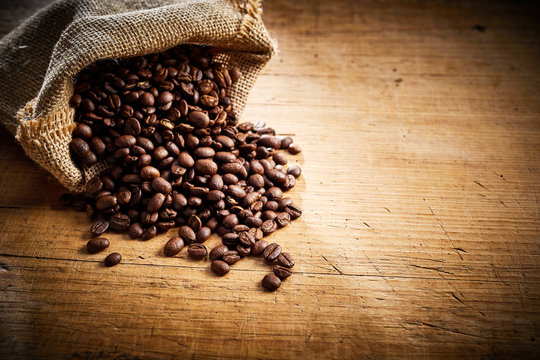 Fresh roasted coffee beans spilling from a sack