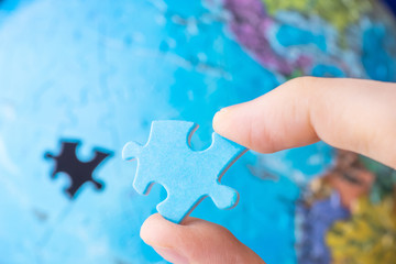 Globalization, world, concept of studying the world, geography - a detail of a blue puzzle in the...